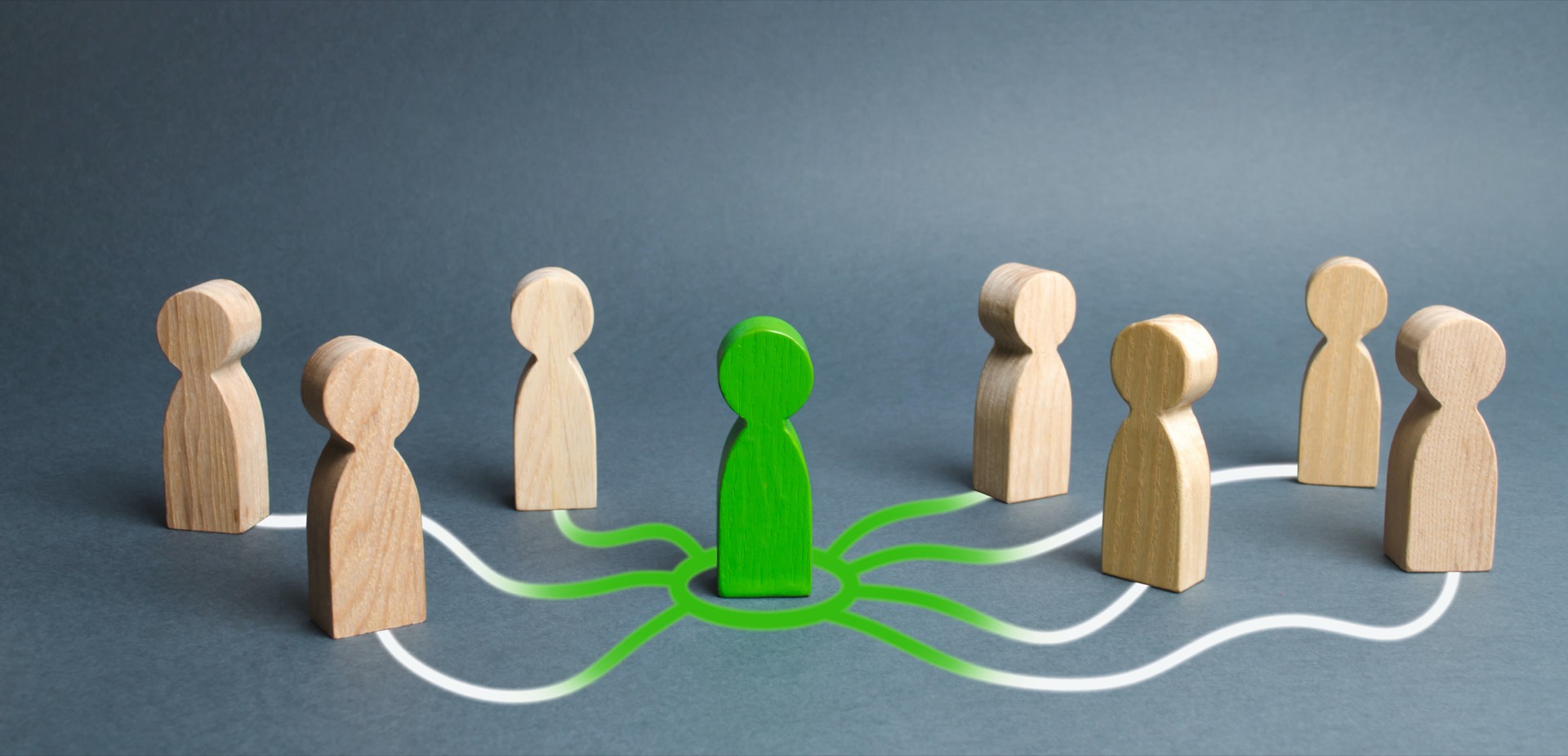 Wooden figurines connected by green and white lines