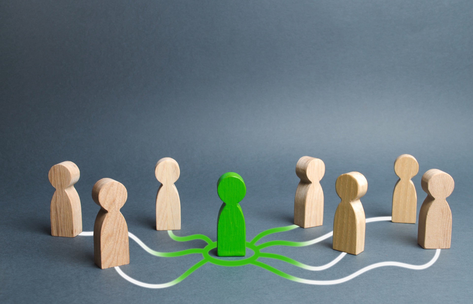 Wooden figurines, with a green figure connecting them
